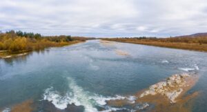 river with colorful trees on either side