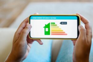 person holding home energy performance stats on a mobile phone app
