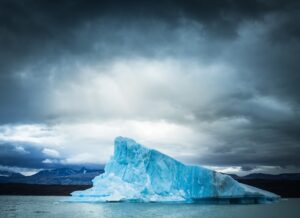 iceberg against overcast sky slowly melting