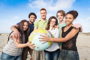 multiracial group of friends holding earth