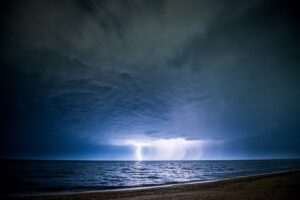 lightening over ocean waters at night
