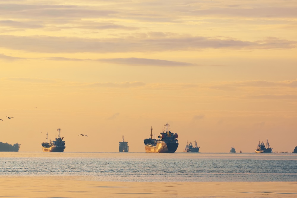Multiple oil tanker ships and fishing boats in the ocean