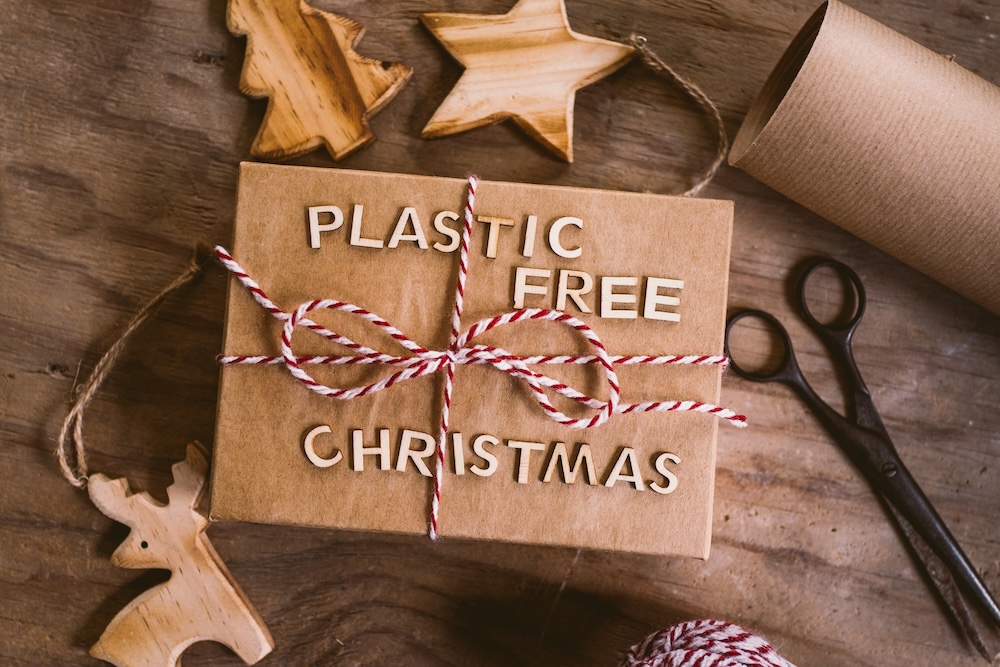 Plastic-free written on brown paper packaging with christmas string tied