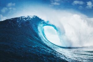 Blue ocean wave against a blue sky