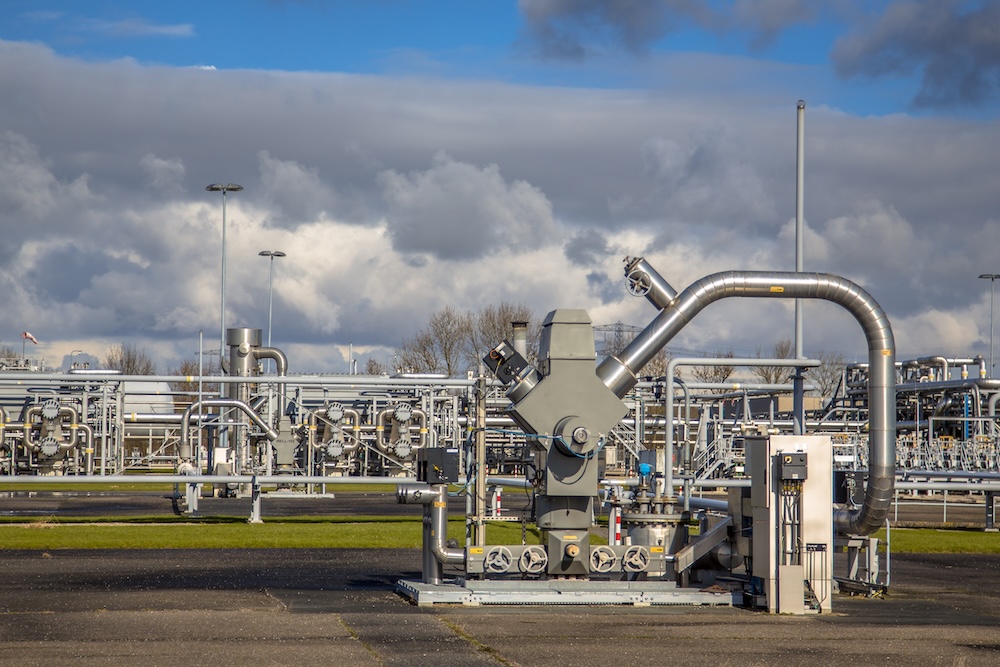 natural gas well with piping in the background
