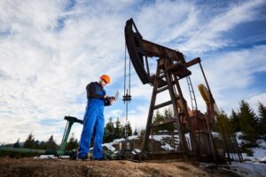 Oil pump jack with a worker and a laptop