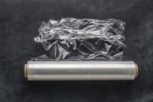 Cling wrap on a roll on a black background