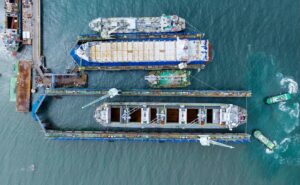 Cargo container carrying containers at a dry dock