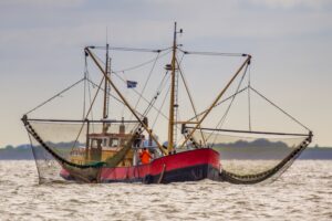 Fishing vessel with large fishing nets on both sides
