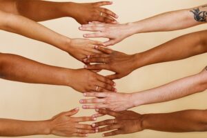 Diverse hands reaching out to each other