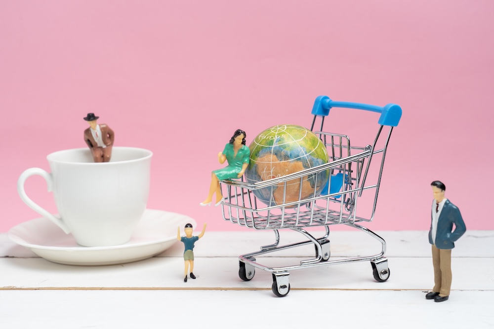 miniature people and cart with earth in the cart