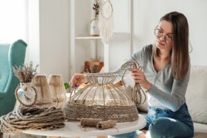 Woman repurposing lamp with jute rope