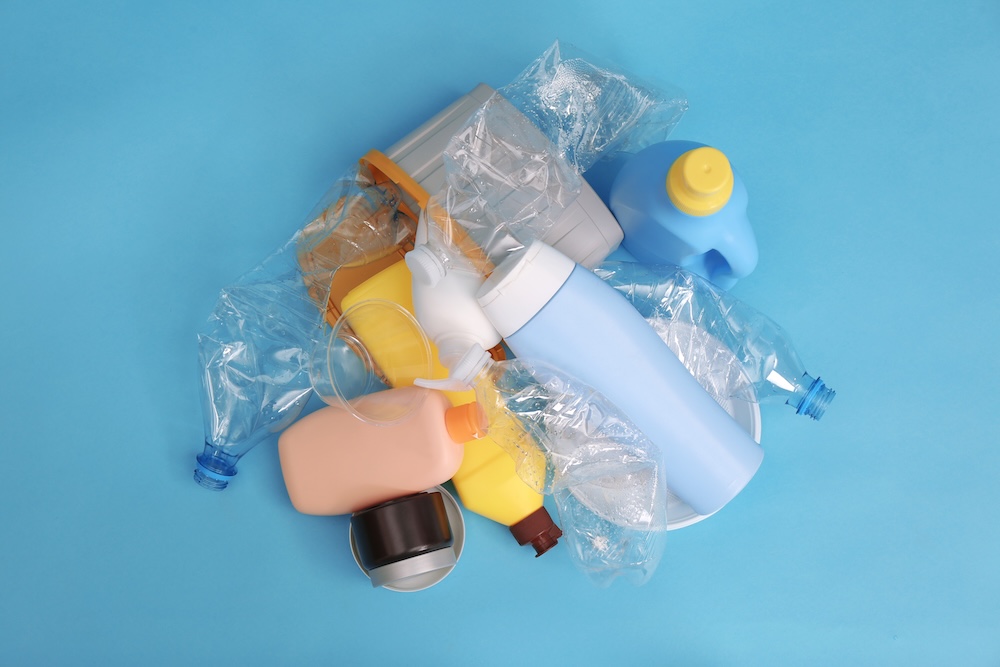 plastic garbage piled up on a blue table